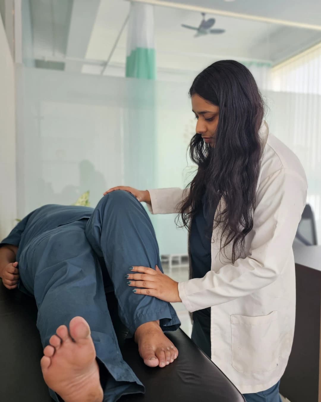 Physiotherapist treating a patient for back pain, Vasanthapura